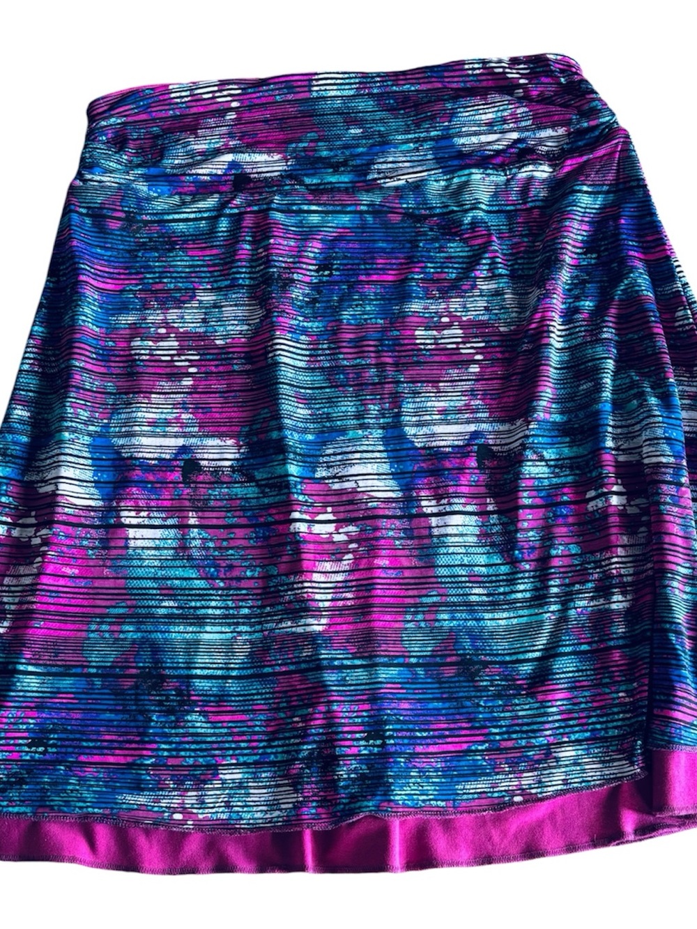 Women's small pull on reversible skirt in a solid magenta and a colorful print.